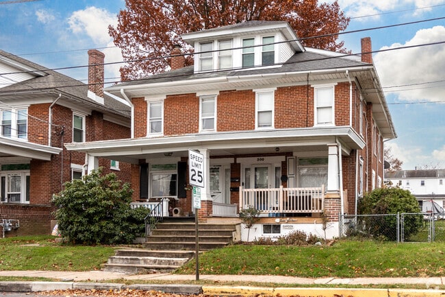 Older brick twin homes with small yards in Boyertown.