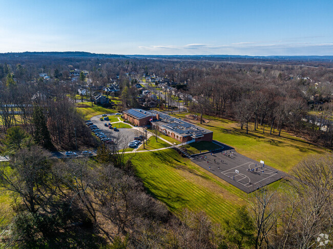 Wilson Elementary School has a campus surrounded by large green areas and trees.