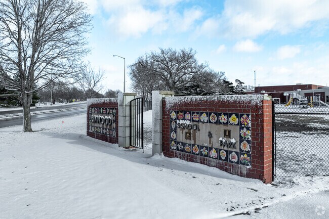 There is a sign for Linwood Elementary School near the main road.