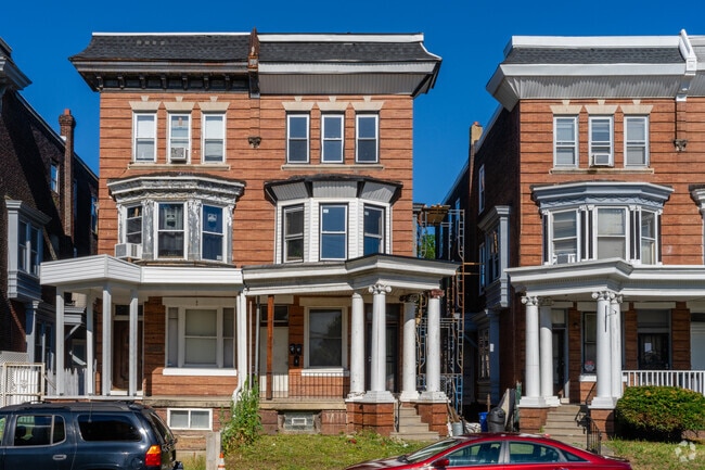 Three story duplexes with pillars over front porches are timeless in Hunting Park.