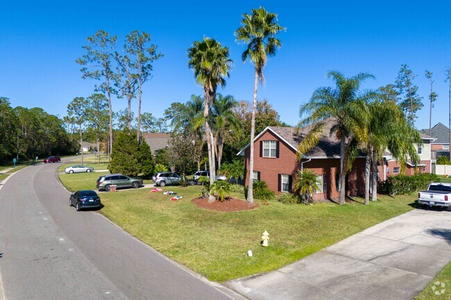Like many Florida homes, palm trees tower over luscious green lawns in Hunters Ridge.