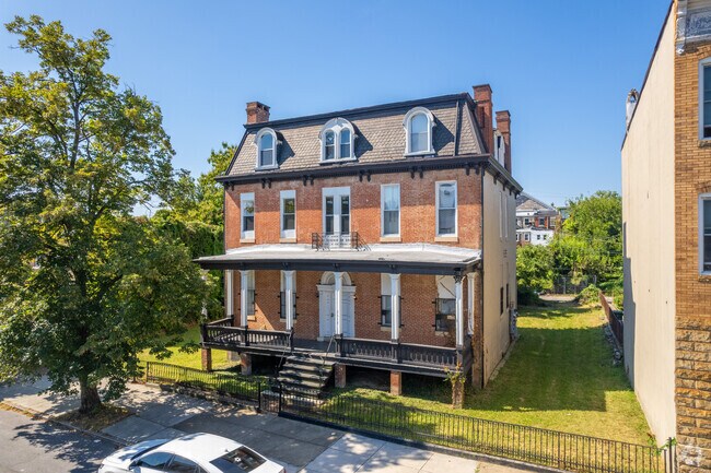 A lone single family home on a block of rowhomes in Penn North.