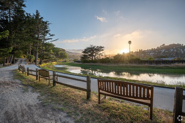 A view of the sun setting behind hillside homes and tranquil waterways in Almonte.