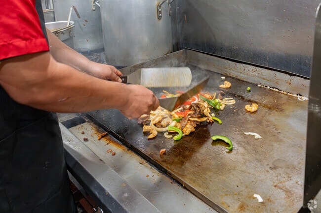 The chef at Old Hacienda Restaurant in Downtown Delano mixes together the fajitas.