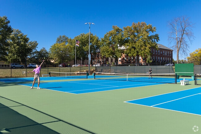 People of all ages enjoy a rousing game of tennis in Des Peres Park.