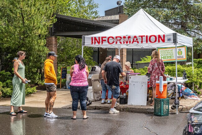 Visitors and residents of Downtown Flagstaff line up for information at a Wheeler Park event.