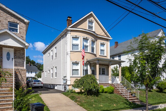 A classic colonial home in North End, personalized with US and Portuguese flags flying outside.