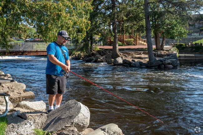 A fisherman tries his luck on the shores of the Shiawassee River in Fenton.