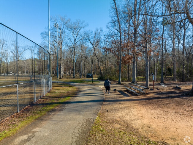 Man Walking dog in Seven Oaks Park.