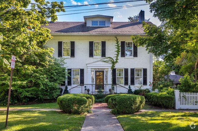 Colonial Revival home style with white stucco exterior located in Downtown Geneva.