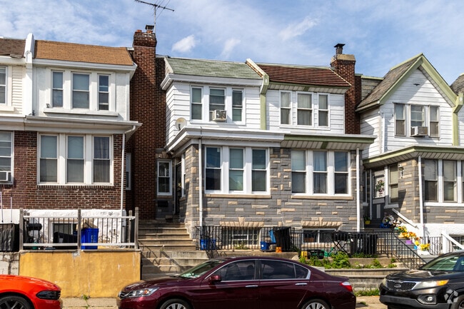 Some rowhomes in Olney have small patios & front lawns.