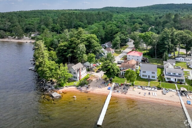 Waterfront homes have beach access to Sebago Lake.