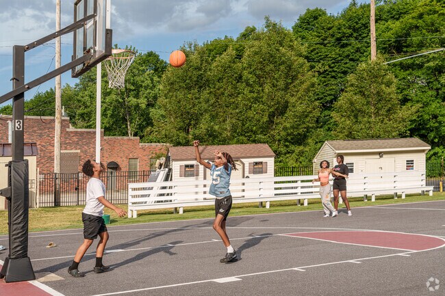 A friendly basketball game takes place as the sun sets on Barefield Park near Fishbach.