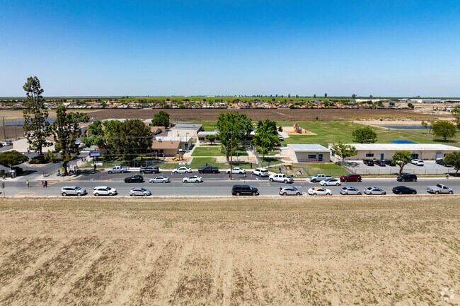 Parent's wait along the street for their students out front of Albany Park Elementary School.