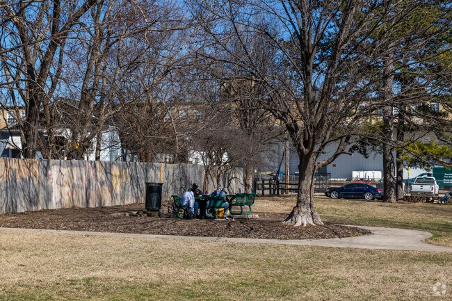 Residents sit in the shade and chat at Field Park.
