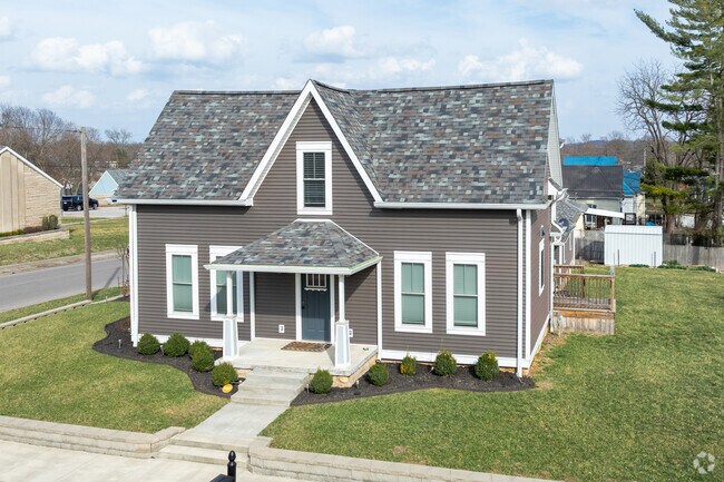 Subdivision homes sit close together along sidewalked streets.
