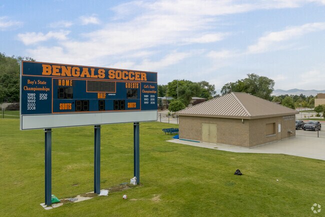 A navy blue scoreboard with yellow detail at Butler Middle School.
