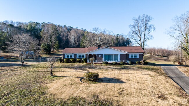 A Lenoir home with a large front yard.
