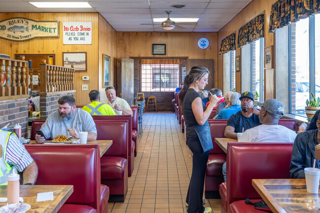 Sunrise Drive-In is a classic local diner with finished wood walls and tables in Glendale Acres.