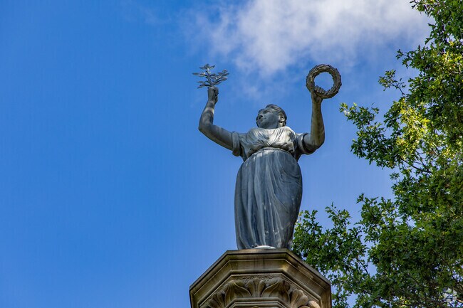 The statues tower above the trees at Monument Park.