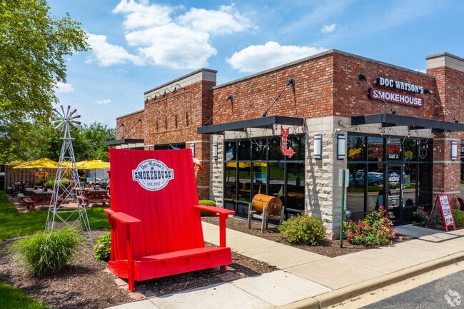 Sit in the giant red chair before enjoying BBQ at Doc Watson's north of Wesglen.