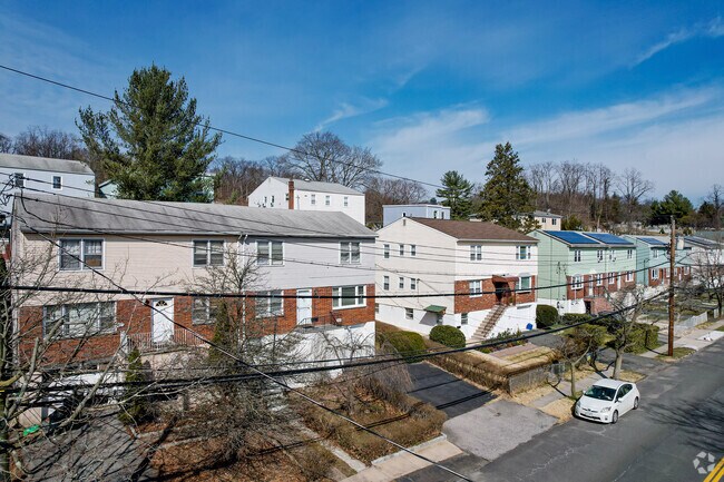 Detached and semi-detached row homes have steps leading to their front doors.
