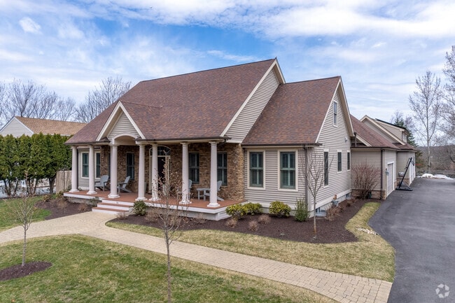 A Cape-style house in Brayton Point features brickwork and classic column accents.