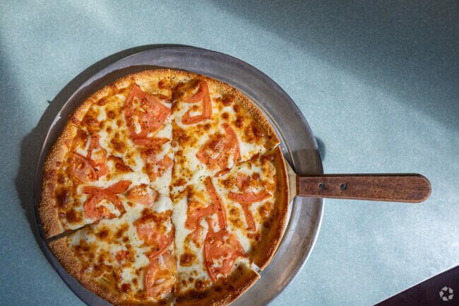 A fresh Margherita pizza from Ocean Deli, a short drive from Atlantic, where small-town dining meets Eastern Shore flavor.