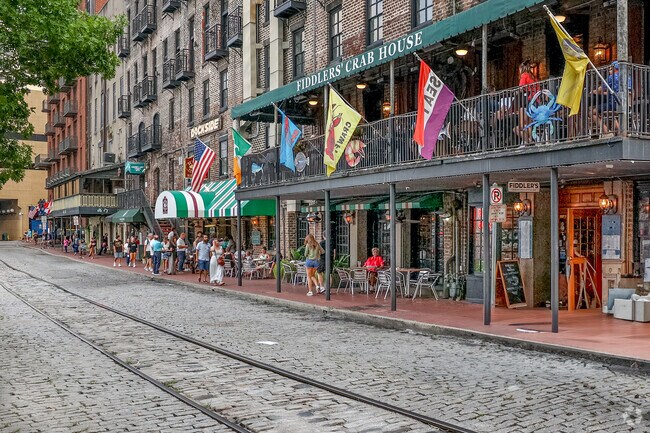 River Street in downtown Savannah has cobblestones and many restaurants near Benjamin Van Clark.