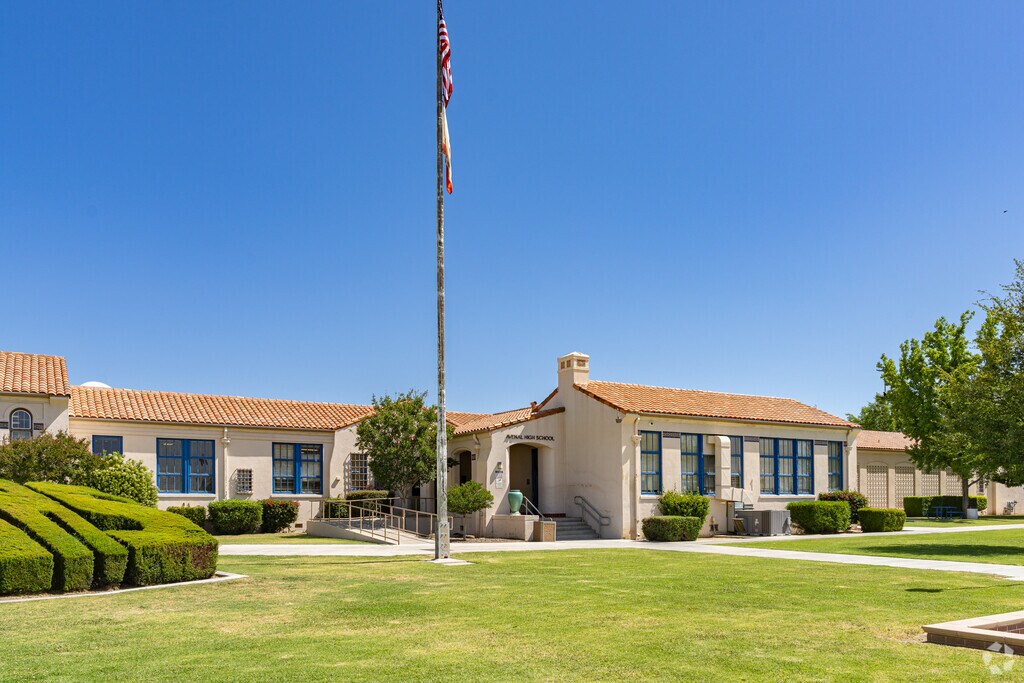 An American flag waves high above the entrance to Avenal High School.