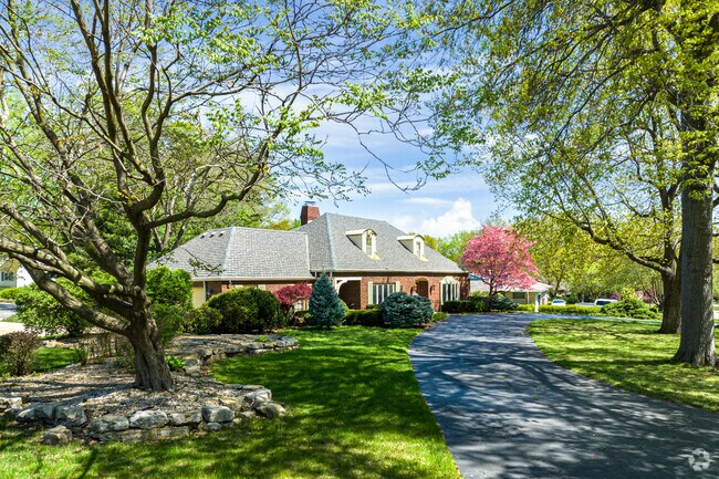 Large homes are hiding in the shade of old trees in Three Trails.