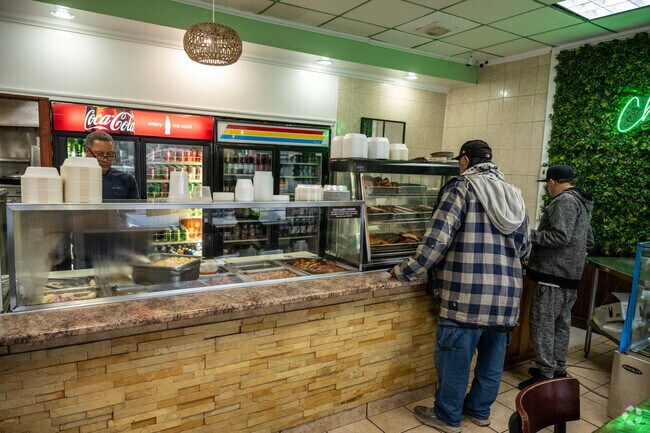Folks order food at Chicharron Restaurant, a Dominican restaurant in Maple-High Six Corners.