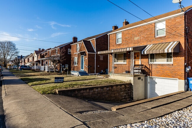 McKeesport Foursquare homes often feature front yards and a small driveway.