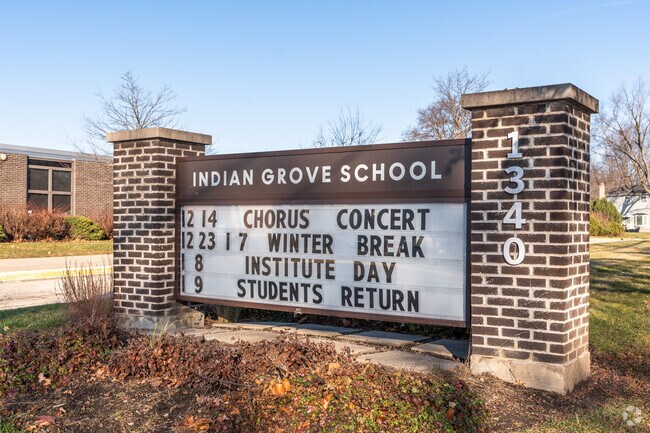 A monument sign outside of Indian Grove Elementary School lists upcoming events.