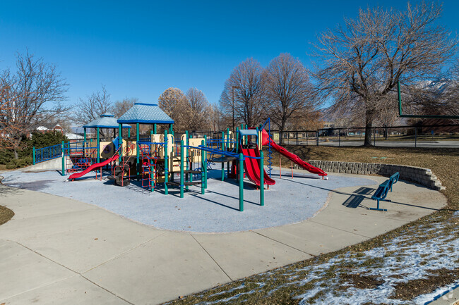 Jordan Valley School has a colorful playground with blue benches.