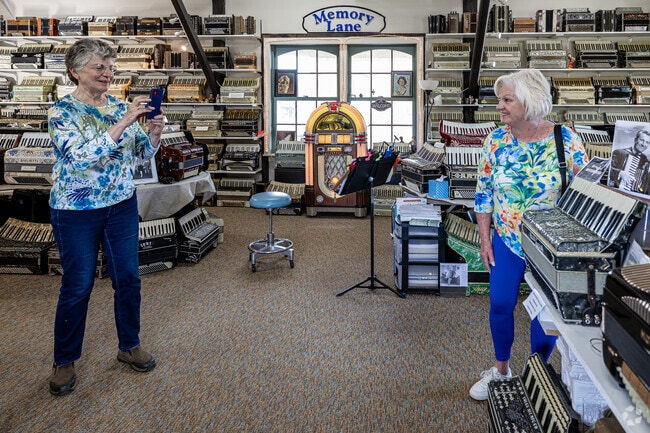 A visitor poses for a photo with Lawrence Welk's accordion at 
New England Accordion Connection & Museum in North Canaan.
