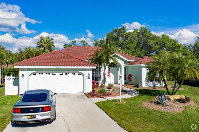 Homes in Bee Ridge feature attached garages and lush yards.
