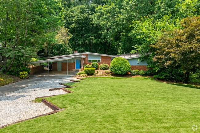Tucked into the woods of Mason Mill, this mid-century modern gem features a large yard and loads of character.