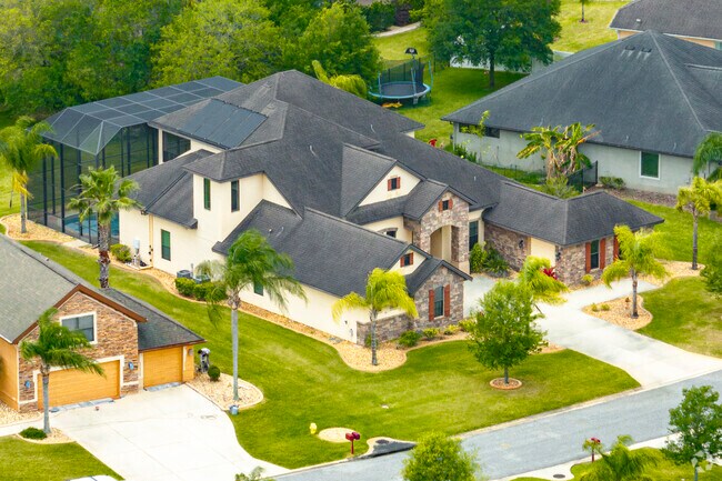 This sprawling Breakaway Trails home boasts many custom upgrades and a large enclosed pool area.