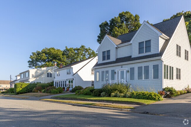 A row of homes including a Cape Cod styled home in the Adams Shore neighborhood of Quincy, MA.