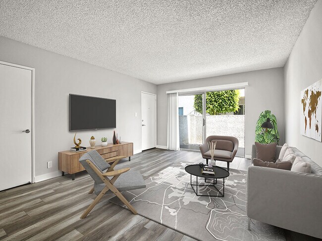 Hardwood floored living room with view of private balcony.