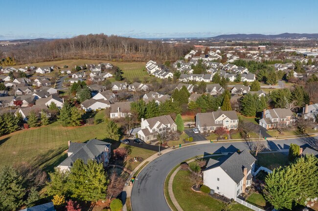 Large homes in Spring Ridge overlook the mountainous terrain and business parks.