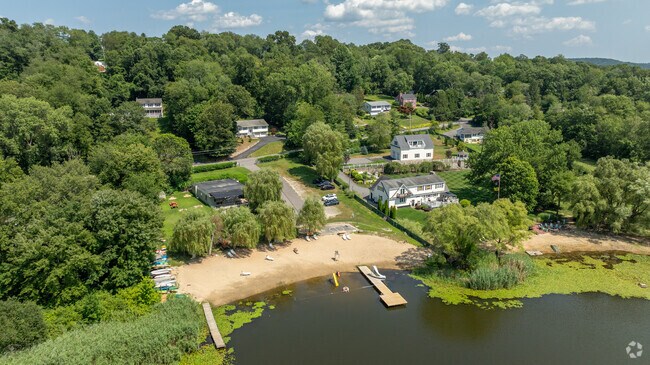 Homes near Tonetta Lake in Brewster offer beach access, boating and scenic wooded surroundings.
