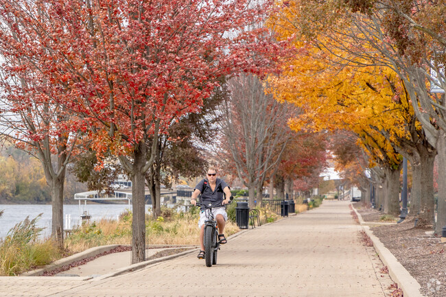 A Southeast Elgin man enjoys a bike ride on the The Fox River Trail near the downtown area.