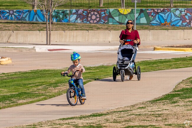 A family enjoys an afternoon stroll at one of Brazos Park's many trails.