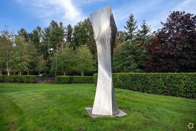 Abstract metal sculpture anchors the plaza at Canyon Park Business Center near Bothell’s tech corridor.
