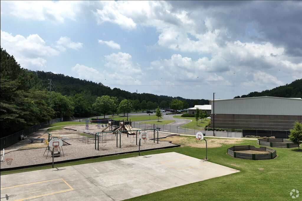 The playground at Pelham Oaks Elementary has slides, swings, basketball court and more.