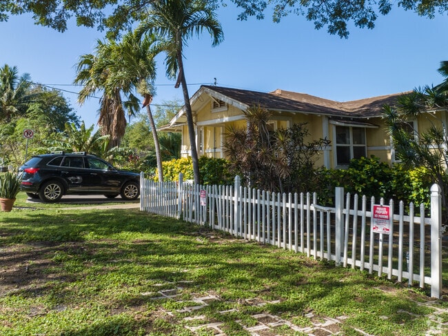A quaint single family home is surrounded by lush landscaping in Kapahulu.