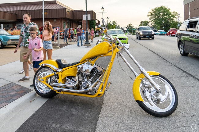 Motorcycles and cars line Park Avenue during the Lombard Cruise Night & Summer Concert event.