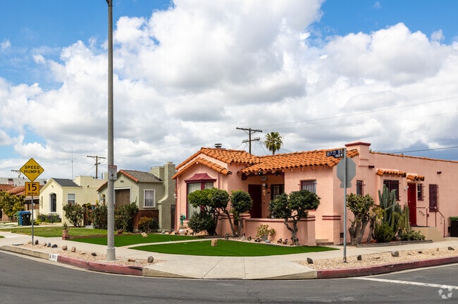 Mediterranean-style home with a unique pop of color and beautiful lawn in Chesterfield Square.